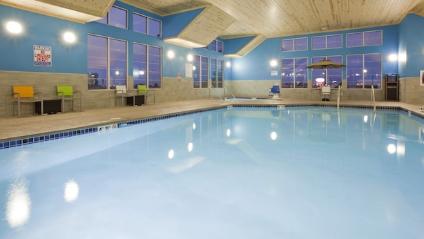 An indoor swimming pool with blue-tiled walls and a wooden ceiling. - Gateway Park Hotel and Suites (Tea)