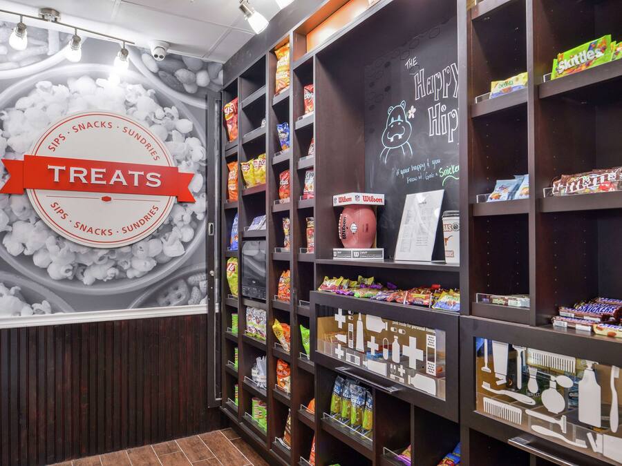 A snack display area with various packaged snacks and a sign reading "THE HAPPY HIP".