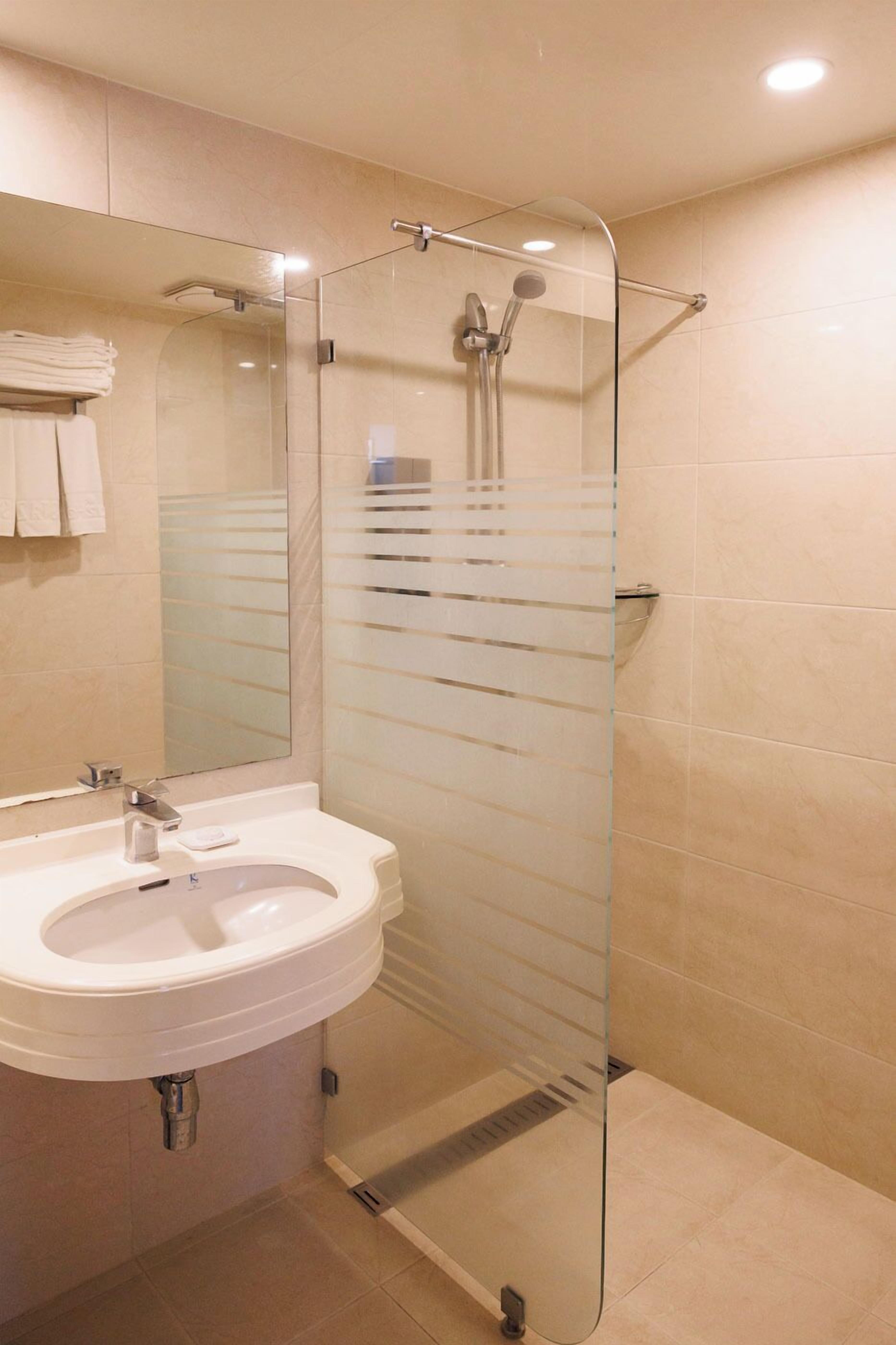 Shower, hair dryer, slippers, towels