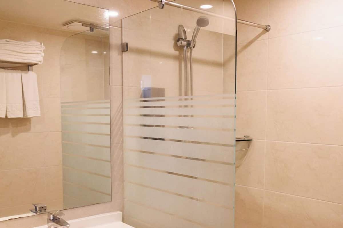 Shower, hair dryer, slippers, towels