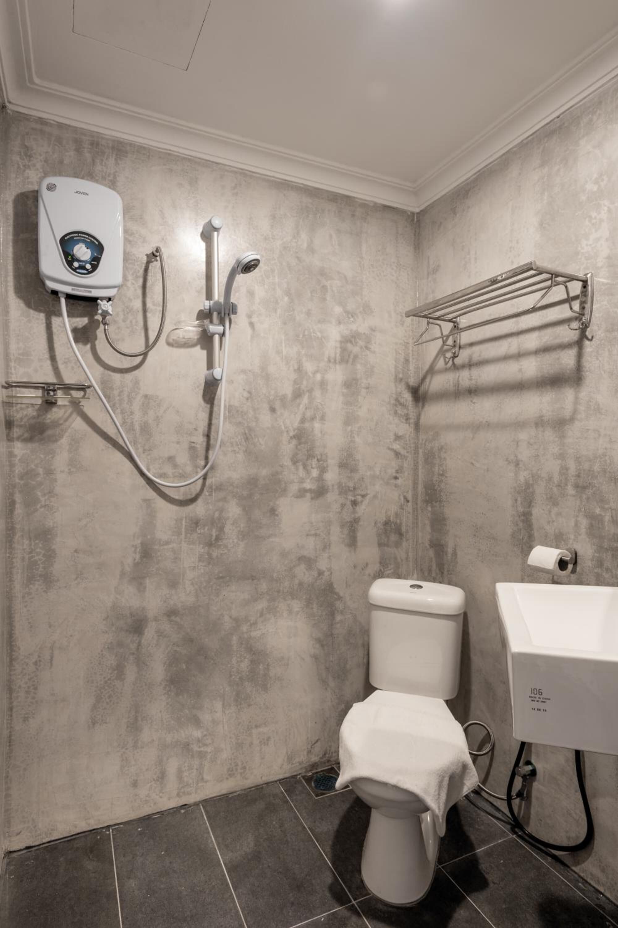 A bathroom with a shower, toilet, and sink.