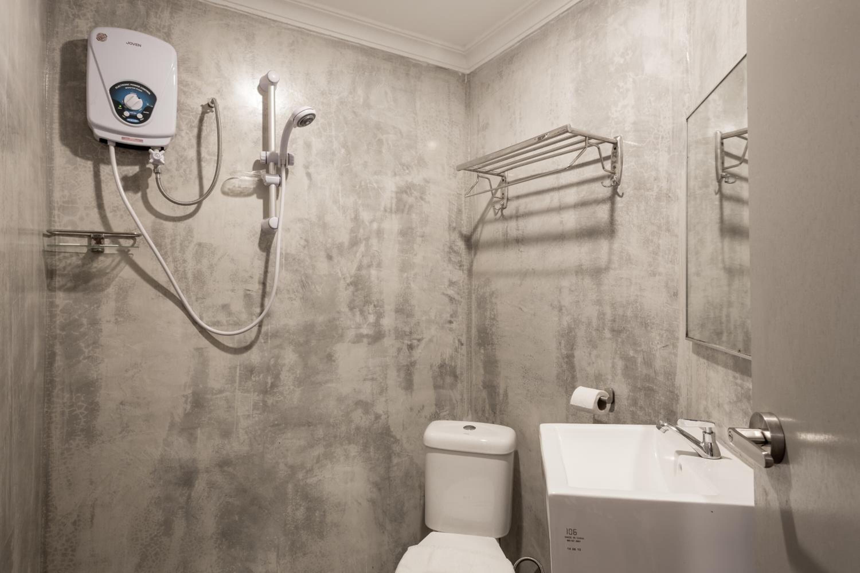 A bathroom with a shower, toilet, and sink.