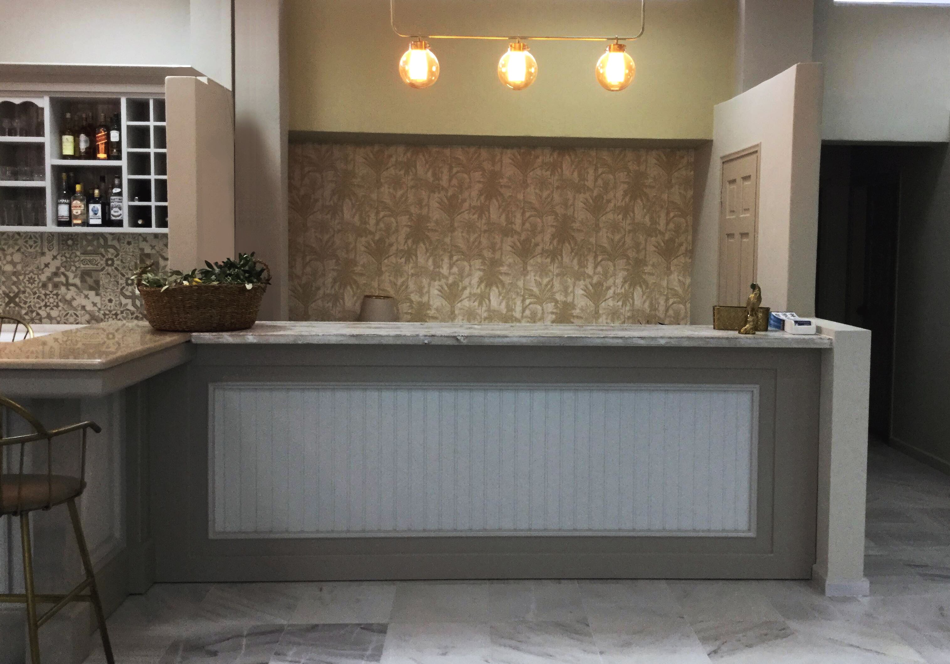 A kitchen with a central island, a bar area, and a wine rack.