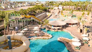 A resort with a large pool area, water slides, and thatched-roof structures. - SENTIDO Reef Oasis Aqua Park Resort - All inclusive (Sharm El Sheikh)