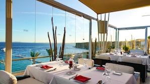A restaurant with tables set for dining, overlooking a coastal view. - SENTIDO Reef Oasis Aqua Park Resort - All inclusive (Sharm El Sheikh)