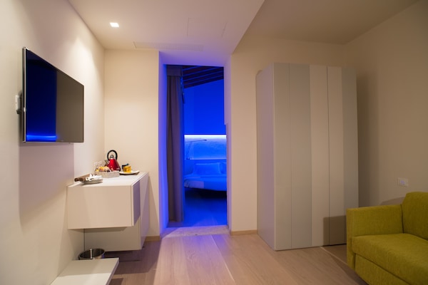 Habitación cuádruple de diseñador, 1 habitación | Área de sala de estar | Televisión de pantalla plana