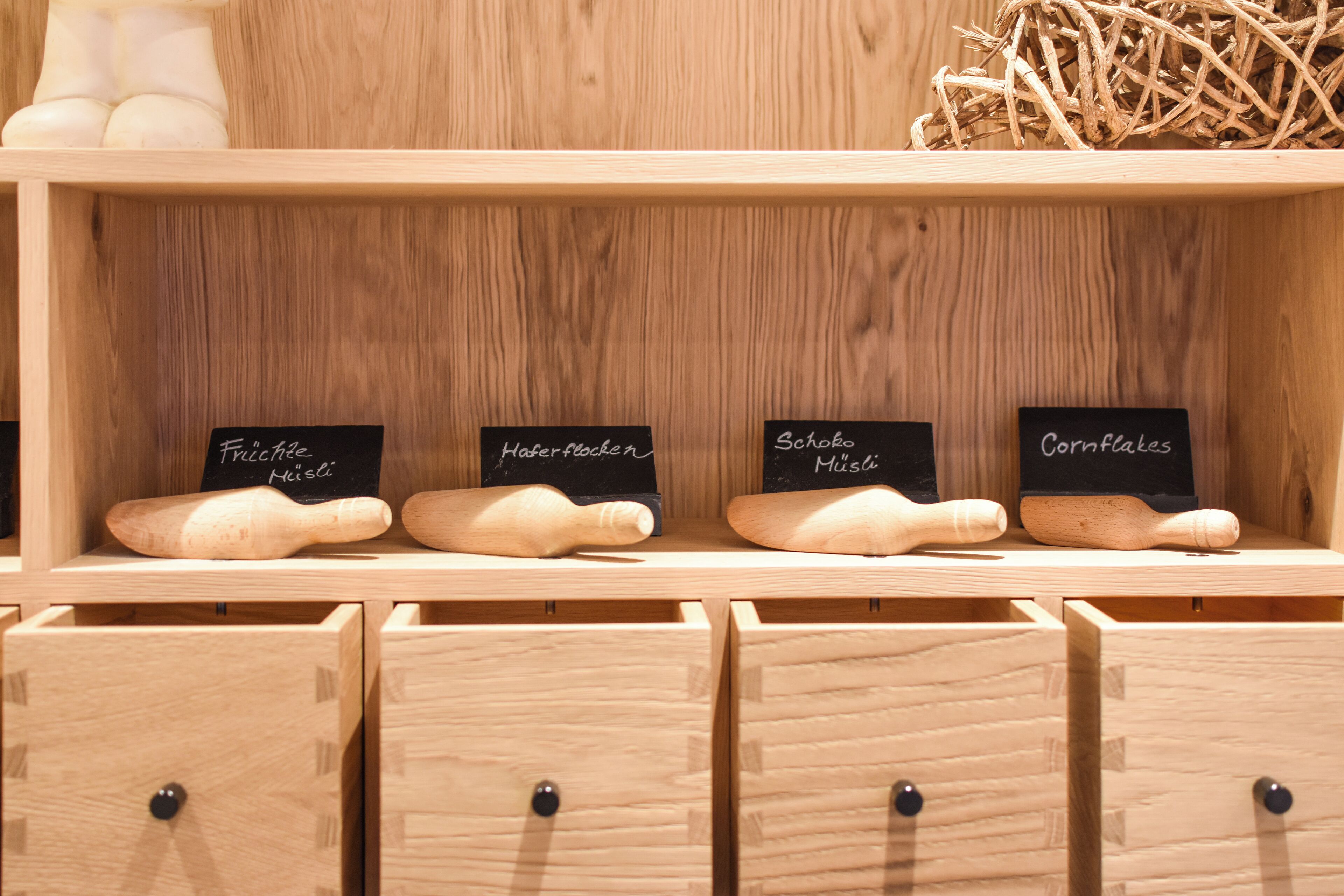 Wooden kitchenware on display with labels.