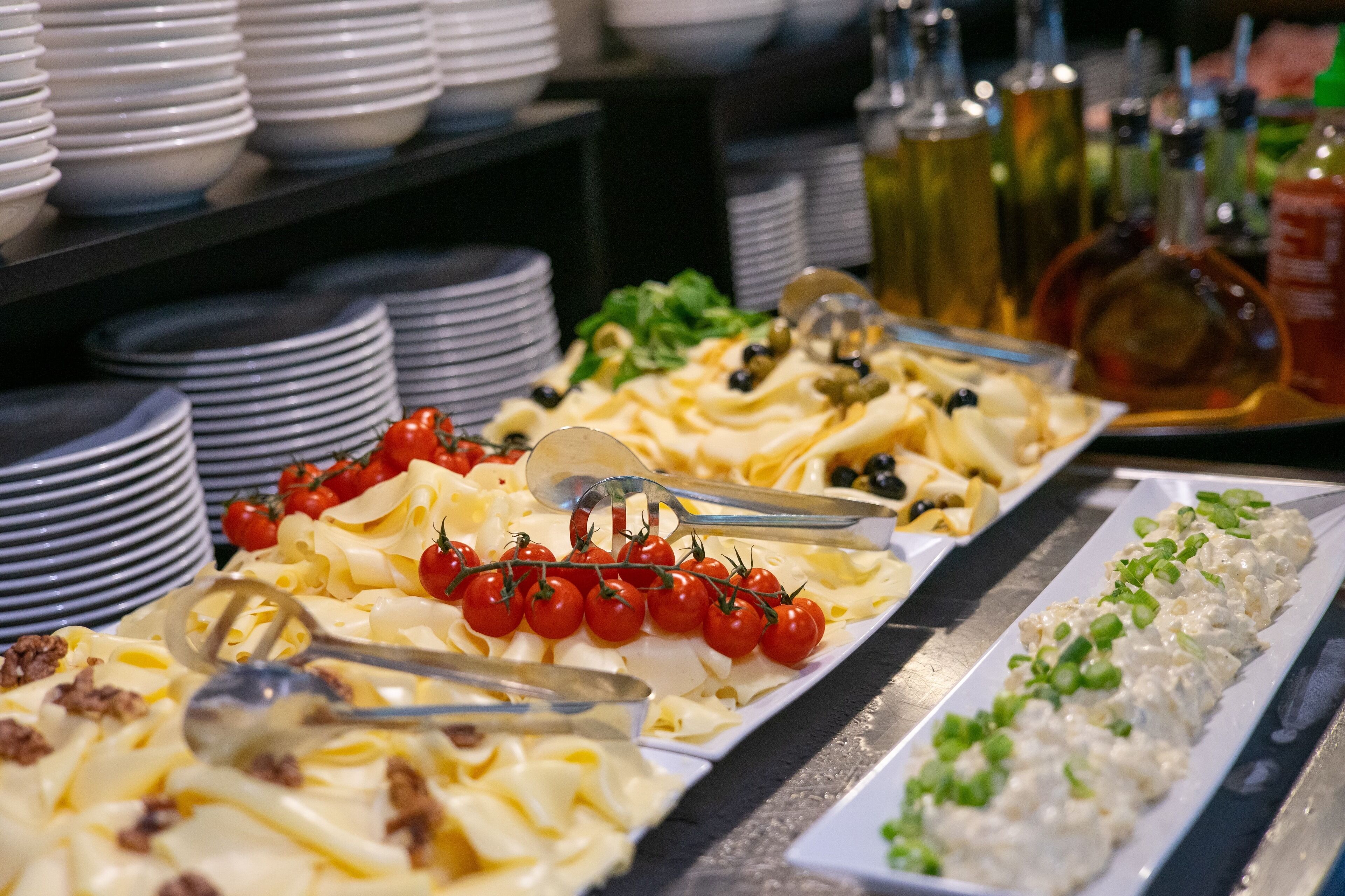 A buffet with various dishes including pasta, salads, and a seafood spread.