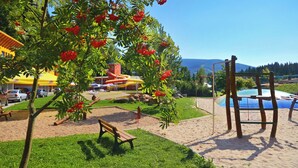 A playground with sand, a bench, and a swing set. - Resort Špindl (Spindleruv Mlyn)
