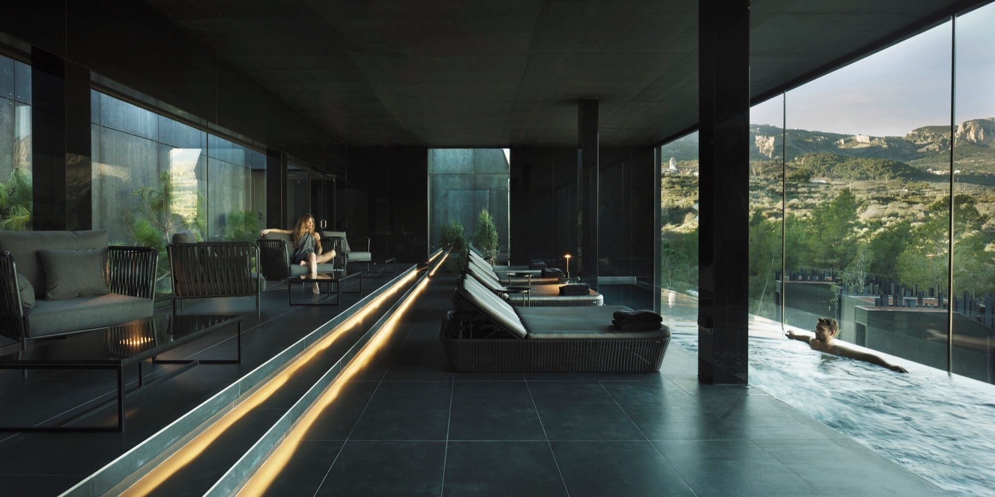 A modern spa area with seating and a pool.