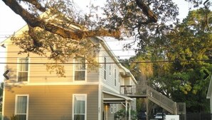 A two-story building with a balcony and a staircase leading to the second floor. - Choo Choo Lofts, 3 br, 2 bath, Full Kitchen - Lafayette, LA (Lafayette)