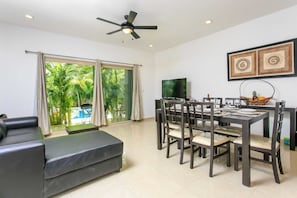 Deluxe Apartment, 2 Bedrooms, Kitchen, Pool View | Living room | Flat-screen TV