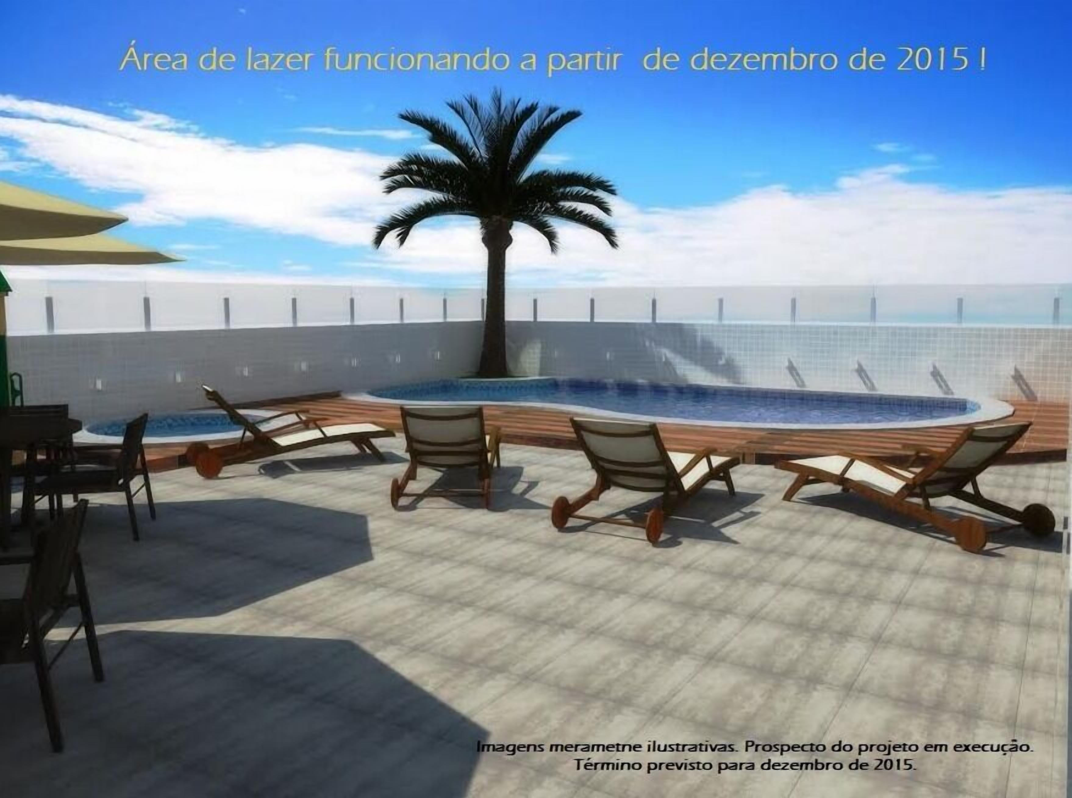 A rooftop lounge area with a pool, lounge chairs, and a palm tree.