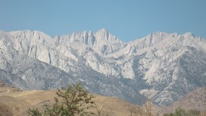 A mountainous landscape with rocky terrain and sparse vegetation. - Trails Motel (Lone Pine)