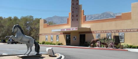 A building with a sign reading "FILM MUSEUM" and "LINCOLN SHOWING SAT 7 PM".