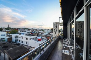 A hotel balcony with a view of the cityscape, including a tower and various buildings. - Hotel Villa Margaritas (Villahermosa)