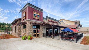 A restaurant with outdoor seating and a stone facade. - Red Lion Inn & Suites Polson (Polson)