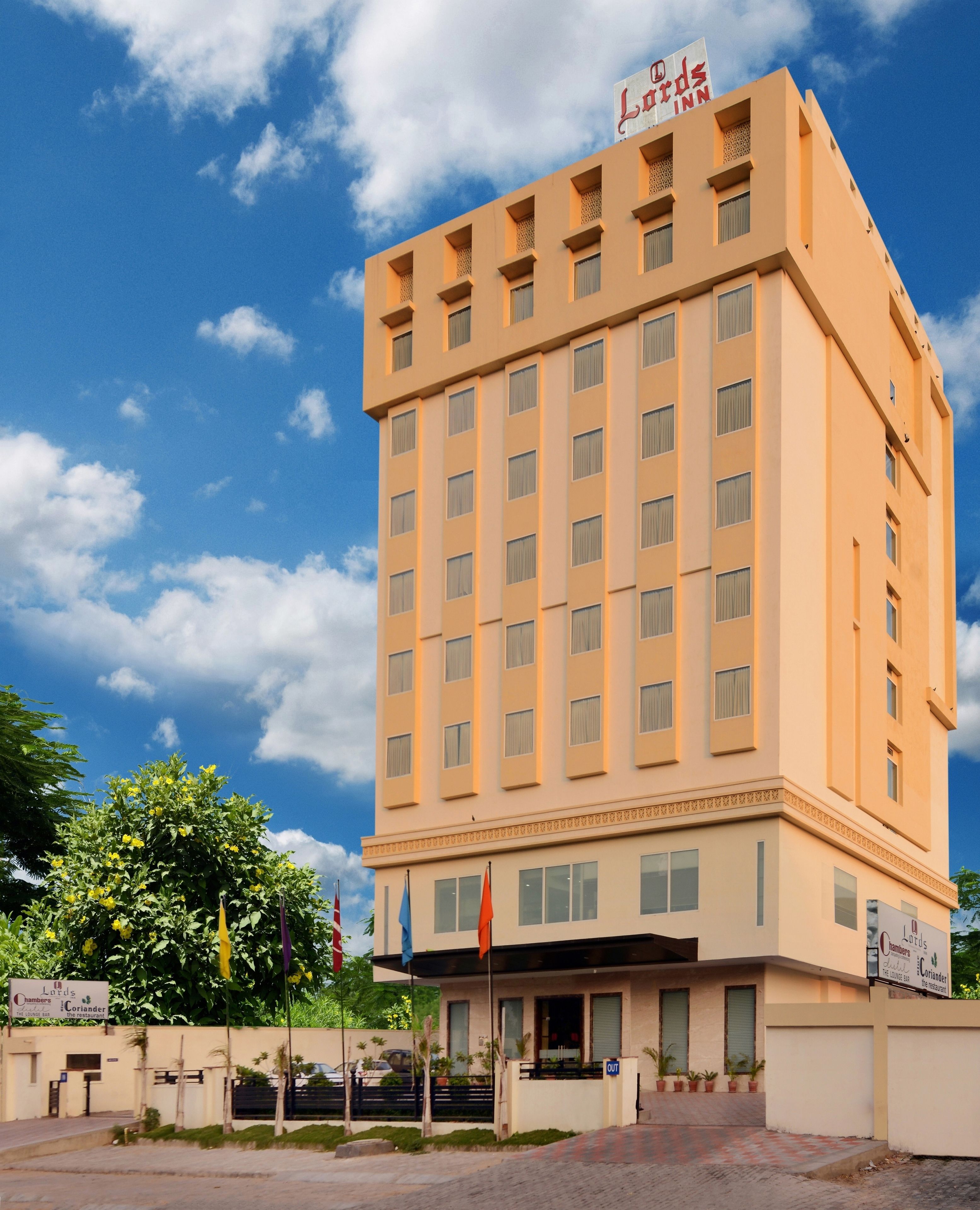 Un hotel de varios pisos con fachada plana, múltiples ventanas y un letrero que indica que es un hotel.