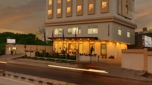 A multi-story hotel with a prominent sign, a well-lit entrance, and a parking area in front. - Lords Inn Jodhpur (Jodhpur)