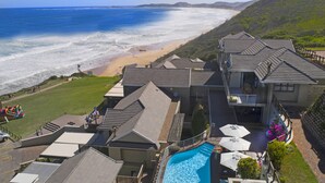 A coastal property with a swimming pool, a beach view, and a ride-on toy car. - Brenton Haven Beachfront Resort (Knysna)