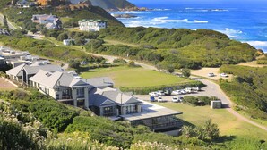 A coastal residential area with houses, a golf course, and a view of the ocean. - Brenton Haven Beachfront Resort (Knysna)