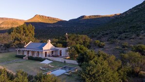 A house with a pool, surrounded by trees and hills. - Mount Camdeboo Private Game Reserve by NEWMARK (Blue Crane Route)