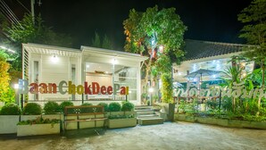 A restaurant with a sign reading "Baan Chok Dee Pal" and a sign in a local language. - Baan Chokdee Pai Resort (Pai)