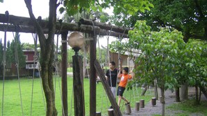 Un parque infantil con puentes de cuerda y columpios.