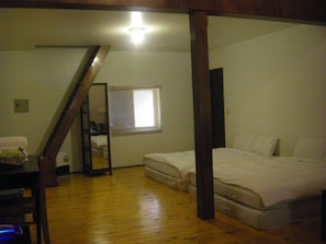 A bedroom with a wooden floor, a bed, a window, and a mirror. - Meihua Lake Leisure Farm (Dongshan)