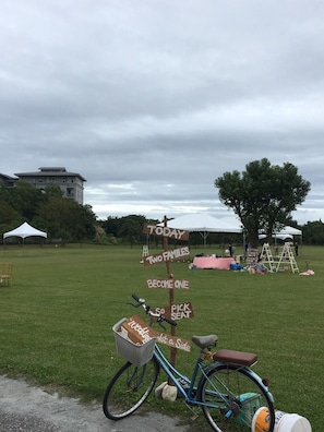 Guests can enjoy a casual outdoor setting with a bicycle and a signpost directing them to a fun gathering.