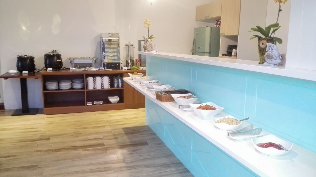 A buffet setup with various food items and a coffee station.
