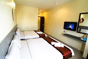 A hotel room with two beds, a television, a mirror, and a shelf with toiletries. - Hotel Seremban Jaya (Seremban)