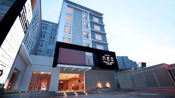 Un hotel moderno con un llamativo letrero digital que muestra su nombre.