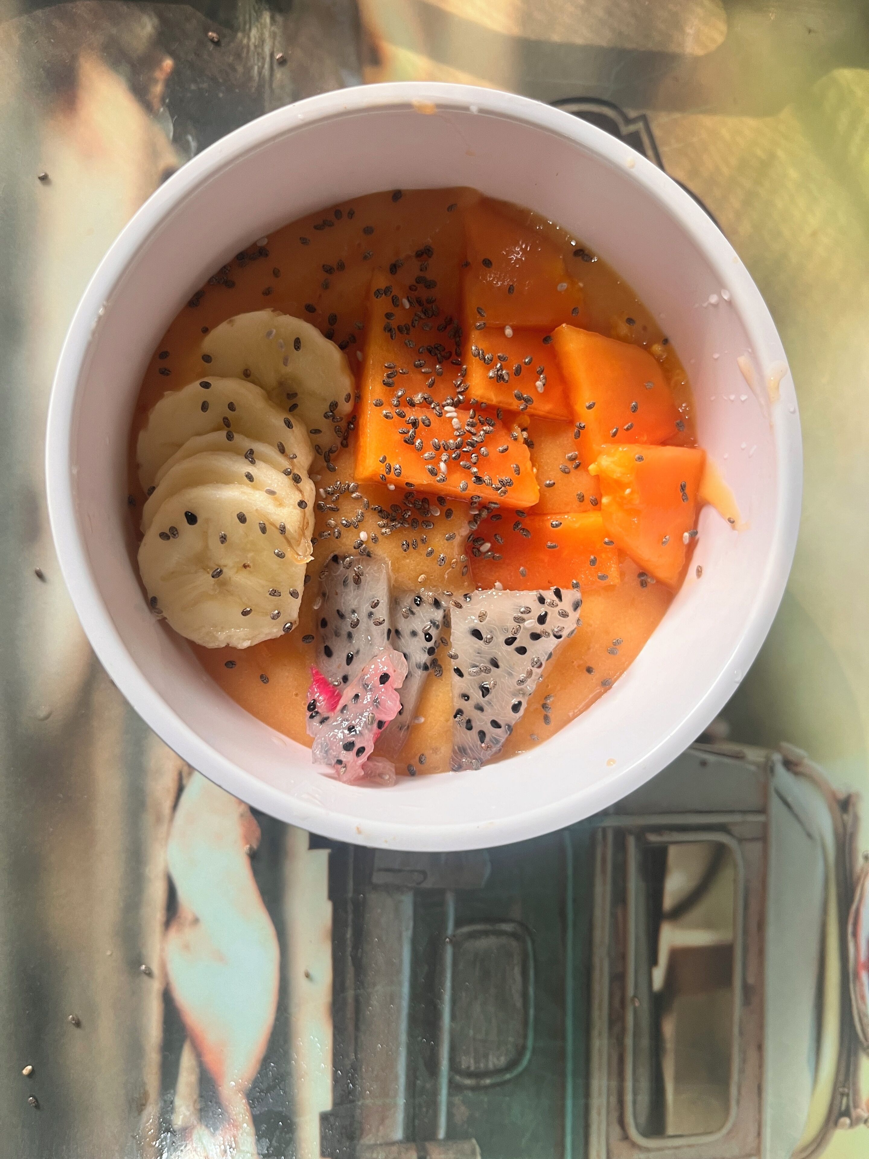 A bowl of food with various fruits and seeds.