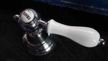 A brass tap with a white handle and the word "GARDO" on it.