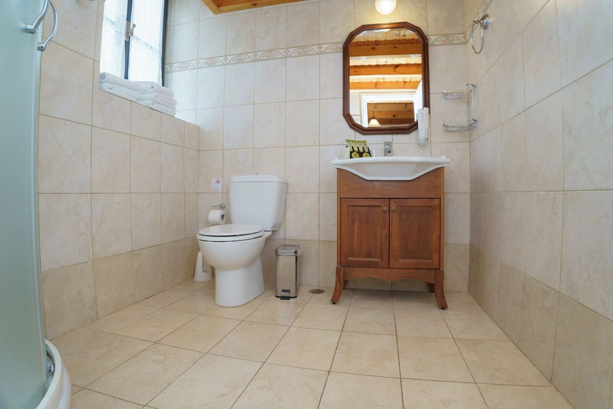 family studio (olympia, split level) | bathroom | shower, free toiletries, hair dryer, bathrobes