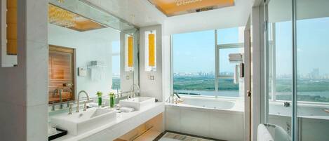 A modern bathroom with dual sinks, a large mirror, and a view of a cityscape through large windows.