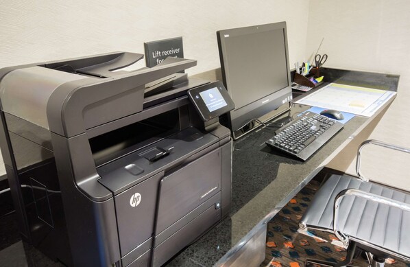 A modern office setup with a large HP printer, a laptop, and a keyboard on a desk. - Hampton Inn & Suites Orlando At SeaWorld (Orlando)