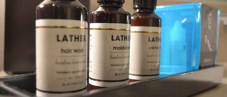 Three bottles of Lather hair wash on a shelf.