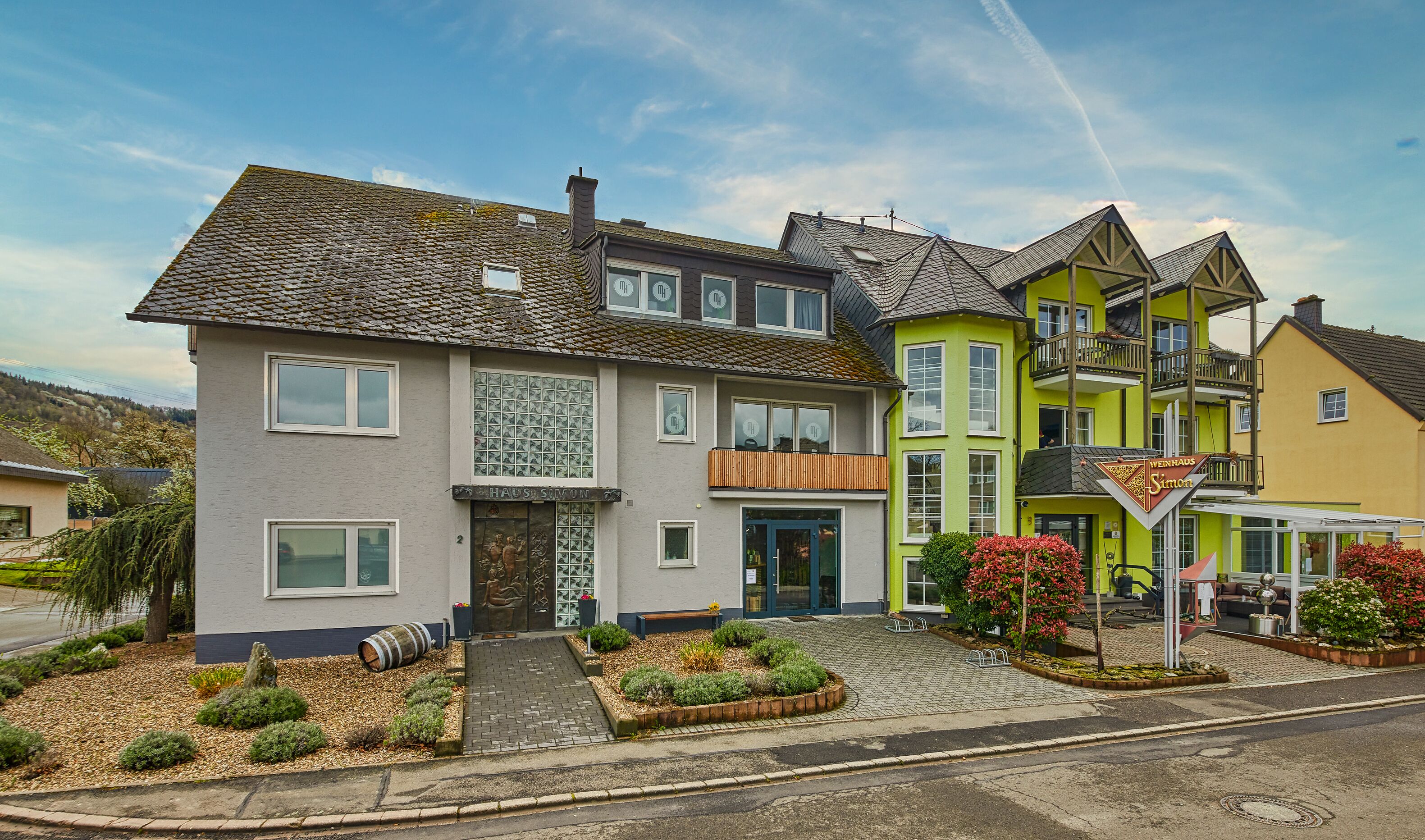 A row of colorful houses with a well-maintained garden in front.