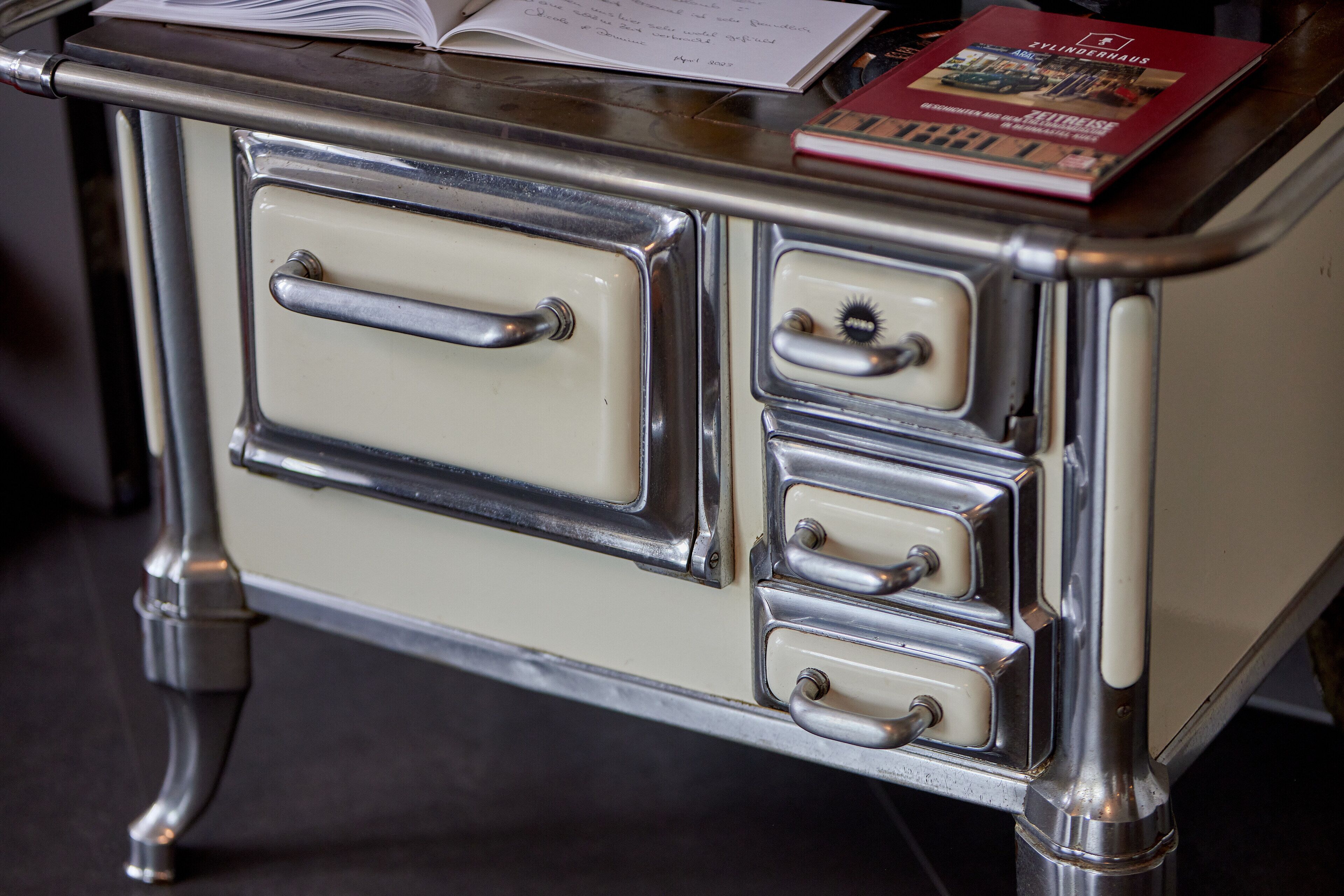 A vintage-style kitchen with a cream-colored stove and chrome accents.