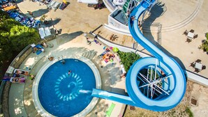 A water park with a large pool, a water slide, and various amenities. - Villa Lovorka - Hotel Resort Drazica (Krk)