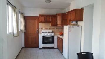 Full-sized fridge, stovetop, cookware/dishes/utensils