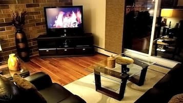 Condo, 1 Bedroom (Uptown 1BSS) | Living room | Flat-screen TV, DVD player