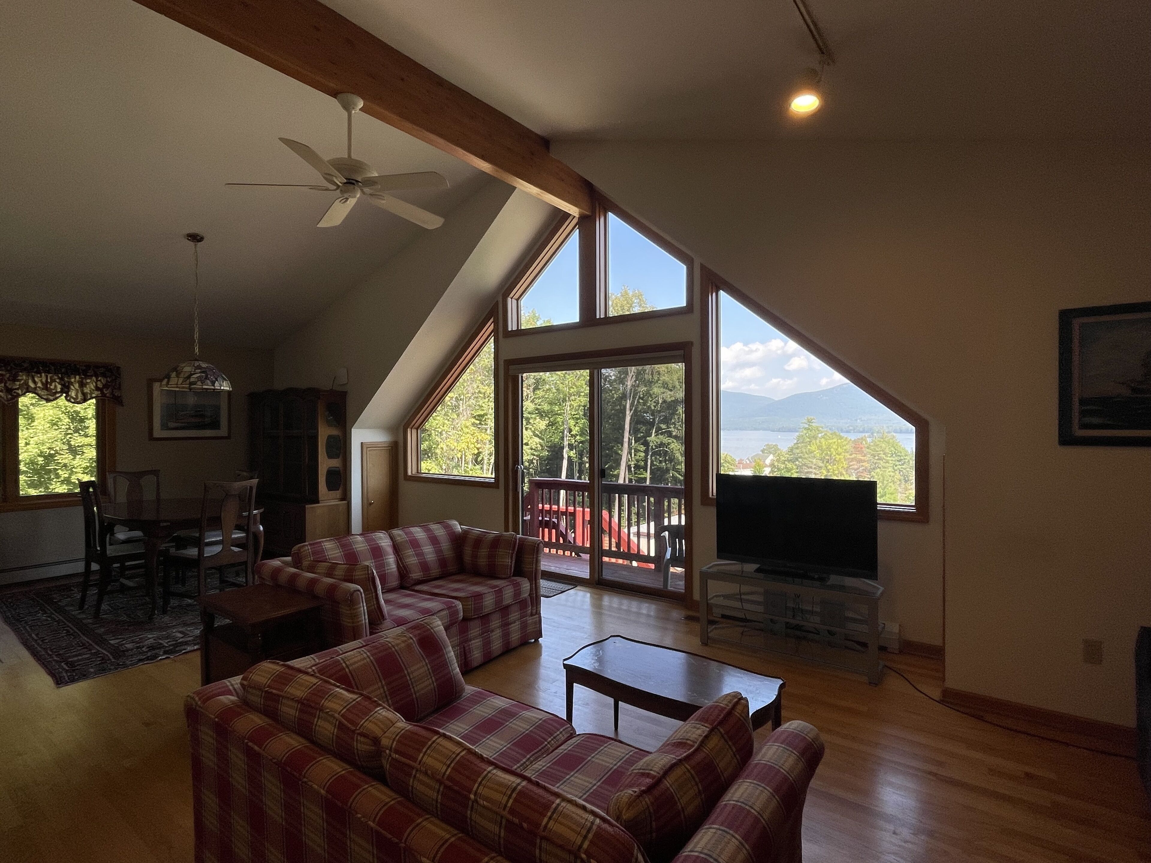 panoramic room, balcony, lake view | living area | flat-screen tv