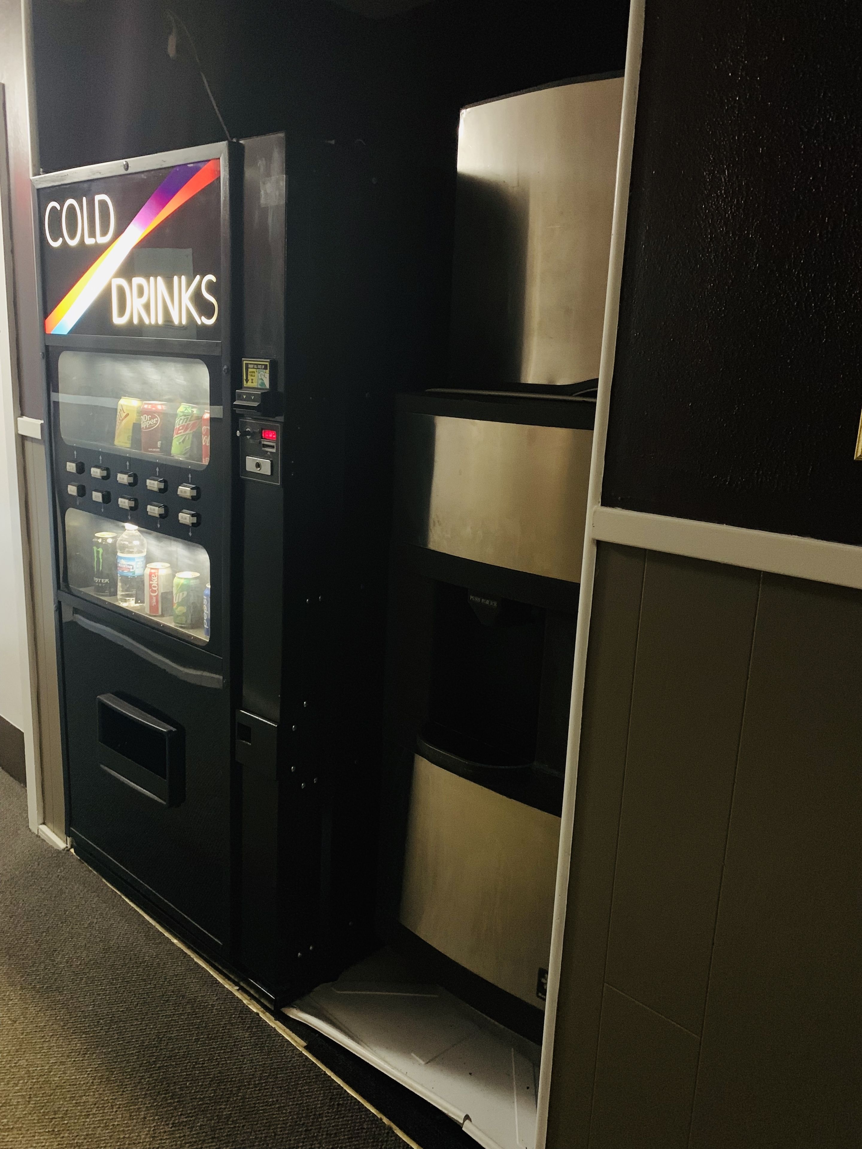 A vending machine labeled "COLD DRINKS" with various beverage options.