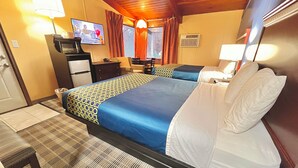 A hotel room with a large bed, a desk, a television, and a window with curtains. - Crossroads Motel (Elkhorn)