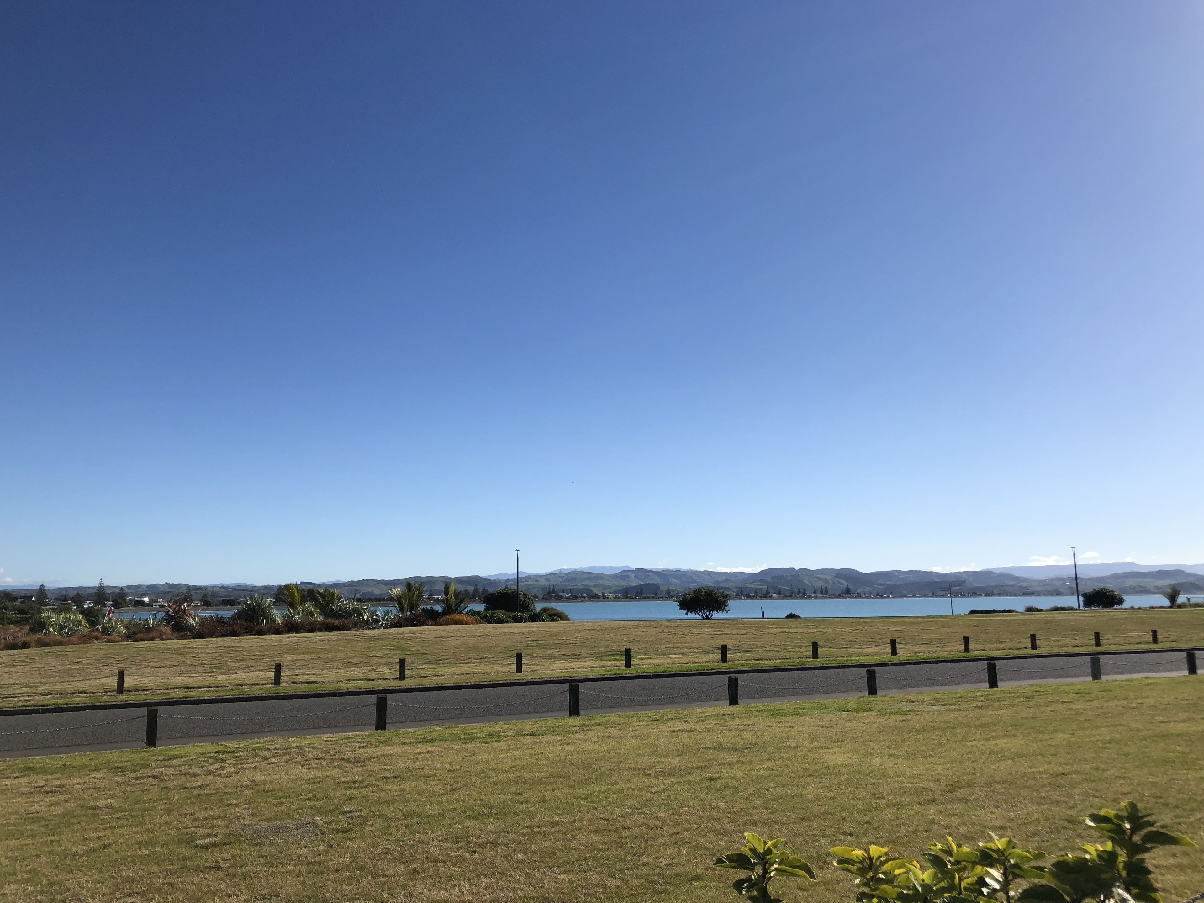 on the beach, black sand, beach towels