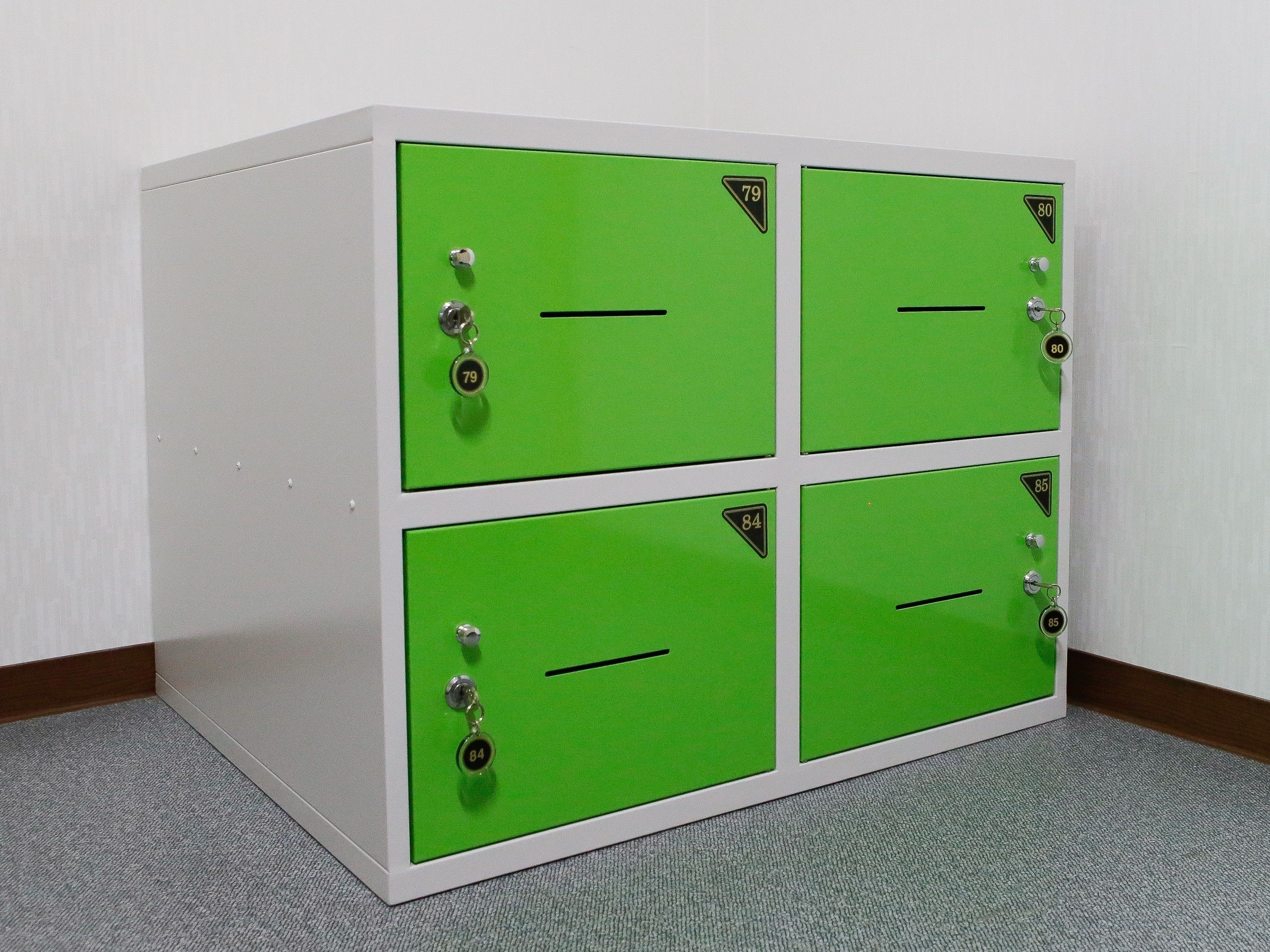 A four-drawer metal filing cabinet with green doors and numbered locks.