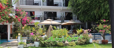 Outdoor pool, open 7 AM to 9 PM, pool umbrellas, pool loungers